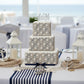 Rope stencil iced onto a multi-tiered nautical themed wedding cake.