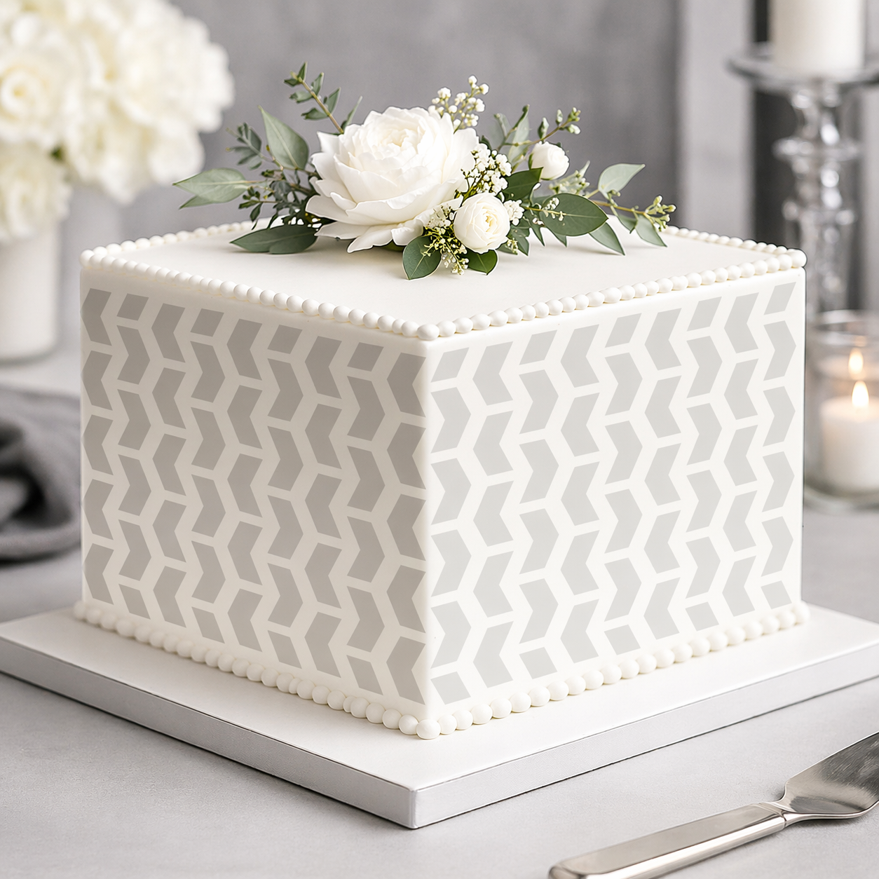 Square cake with geometric pattern and floral decoration on a light background