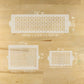 Three decorative stencils with measurements on a wooden surface