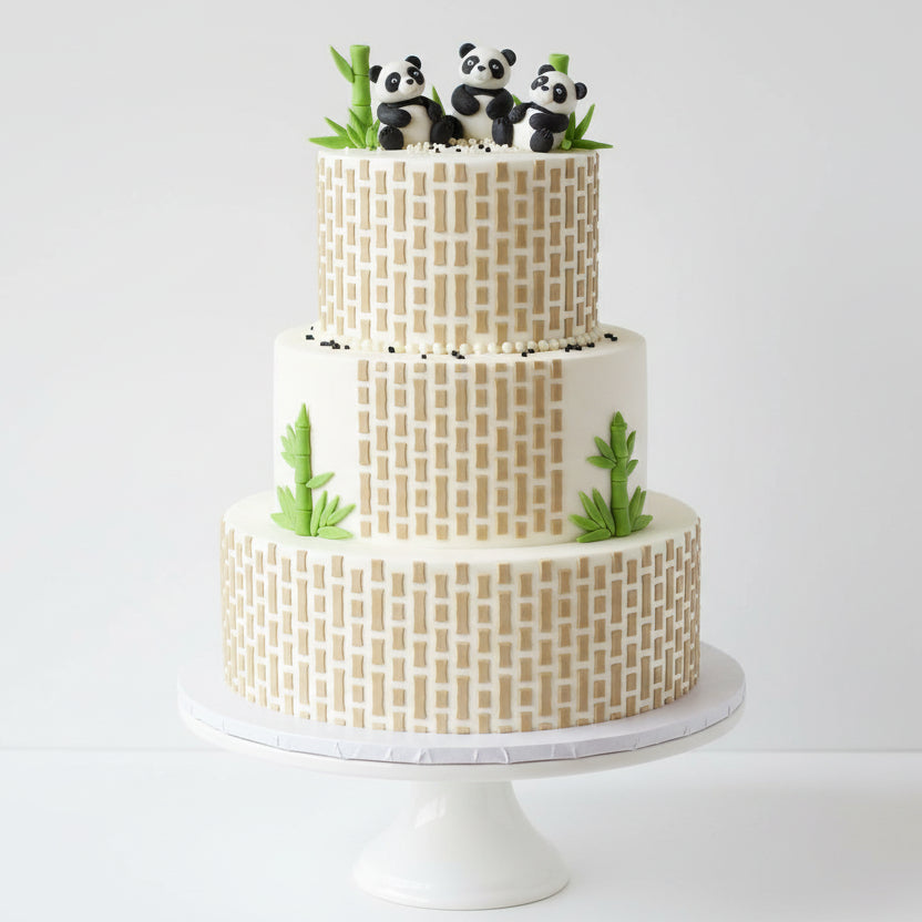 Bamboo pattern stenciled onto the sides of a cake with pandas