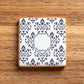 Decorative iced cookie with a blue and white pattern on a wooden surface