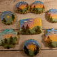 Decorative cookies with scenic designs on a wooden surface