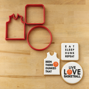 Basketball Messages set stenciled onto three white flooded cookies next to three matching cookie cutters. 