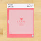 Pink cookie stencil with 'Class of 2026' text on a wooden surface