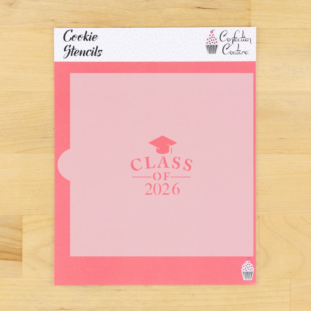 Pink cookie stencil with 'Class of 2026' text on a wooden surface