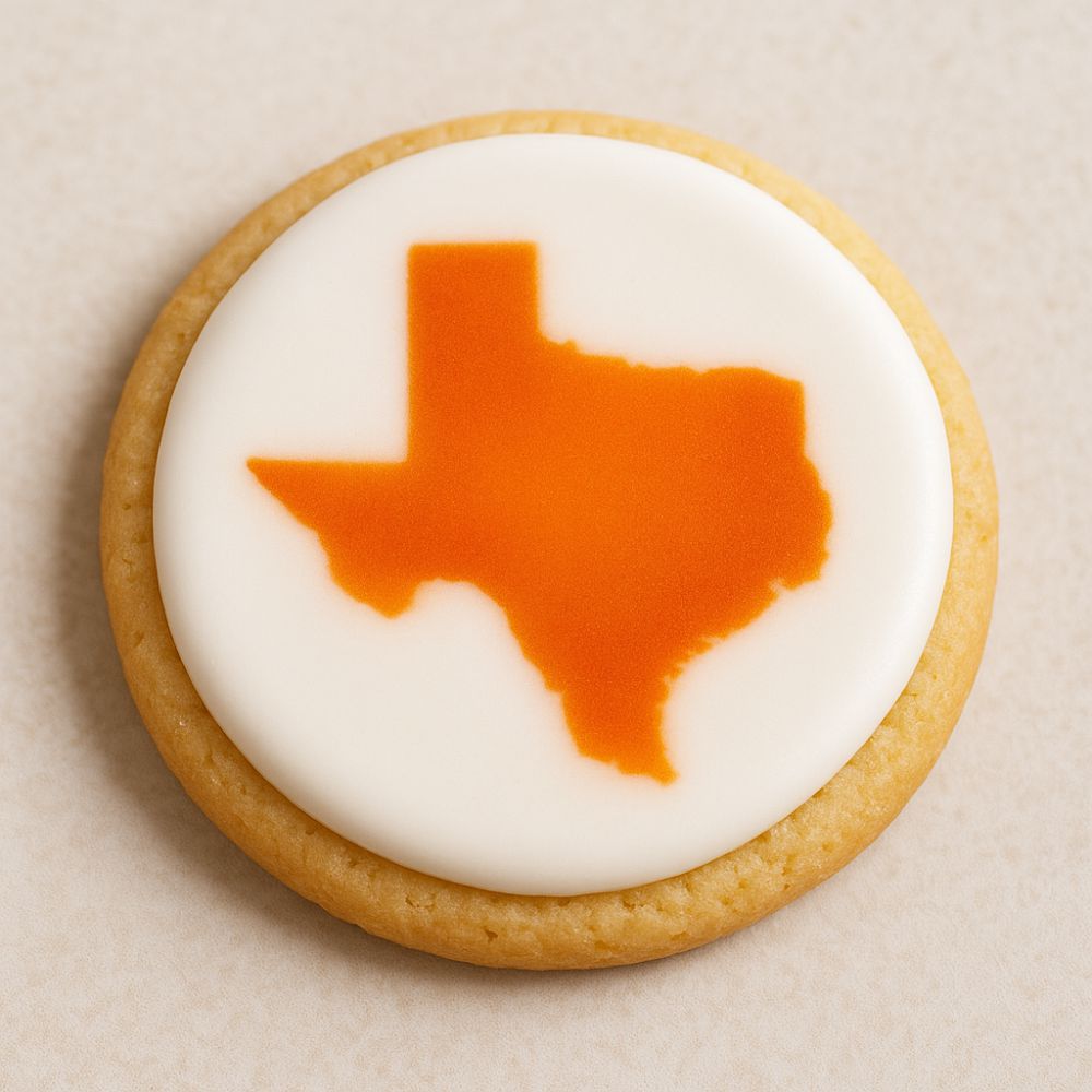 Cookie with Texas-shaped orange icing on a beige background