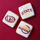 Iowa State themed cookies featuring Cyclone Nation and State logos, perfect for fans and game day treats.