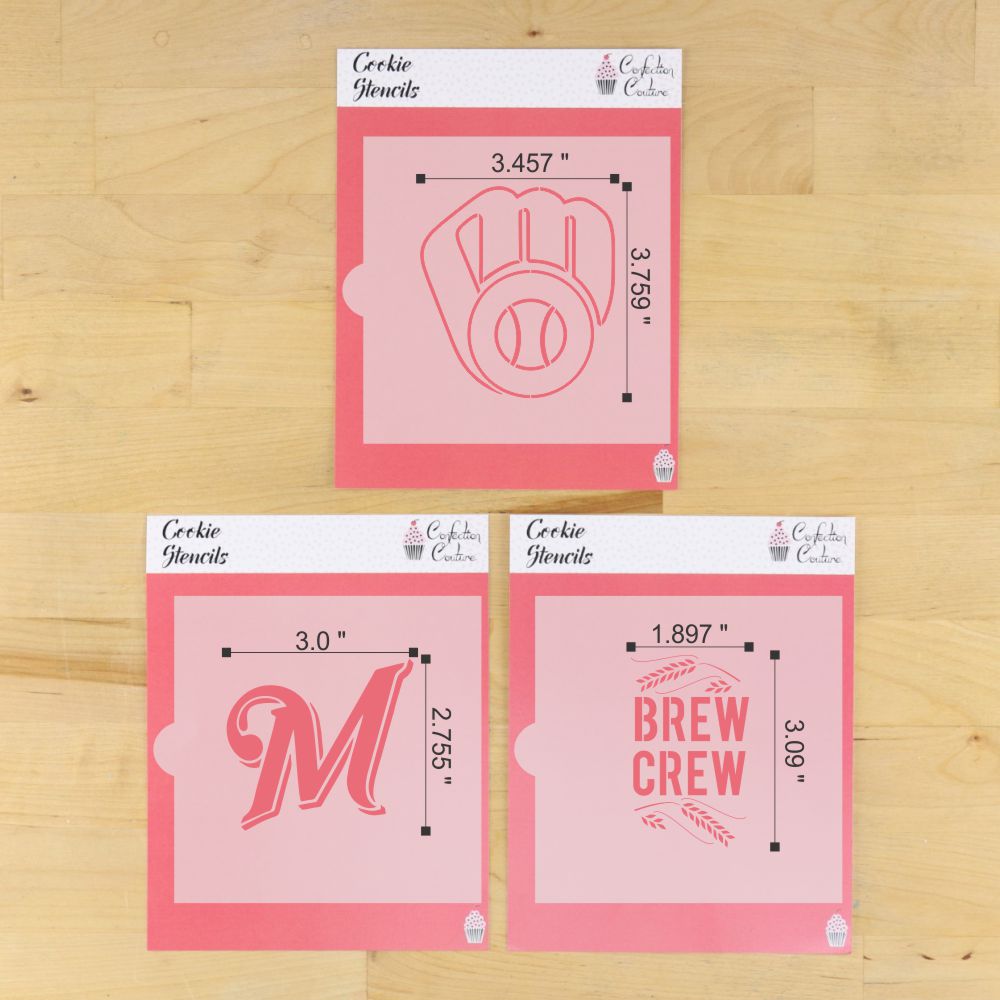 Three pink cookie stencils with measurements on a wooden surface