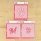 Three cookie stencils with different designs on a wooden surface