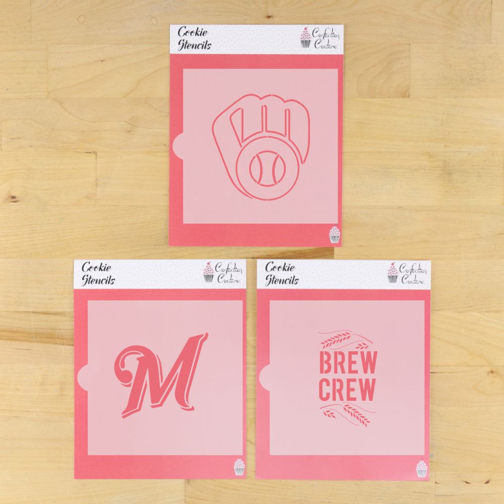 Three cookie stencils with different designs on a wooden surface