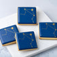 Cookies with blue icing and stenciled gold Libra star constellation.