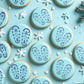 Blue cookies with festive Santa boot print designs on a blue background