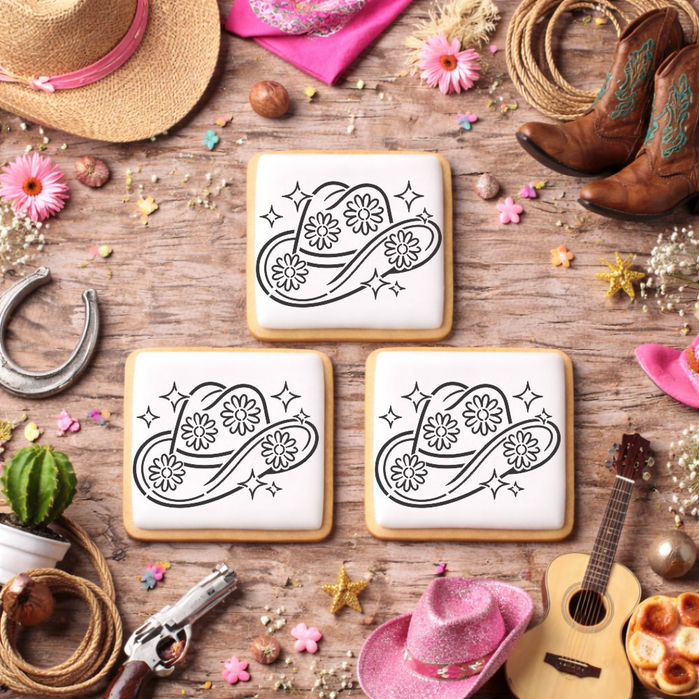 Decorative cookies with cowboy hat designs on a rustic wooden table with cowboy-themed decorations.