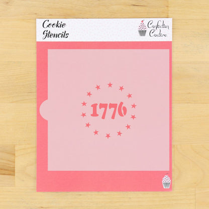 Pink cookie stencil with '1776' design on a wooden surface