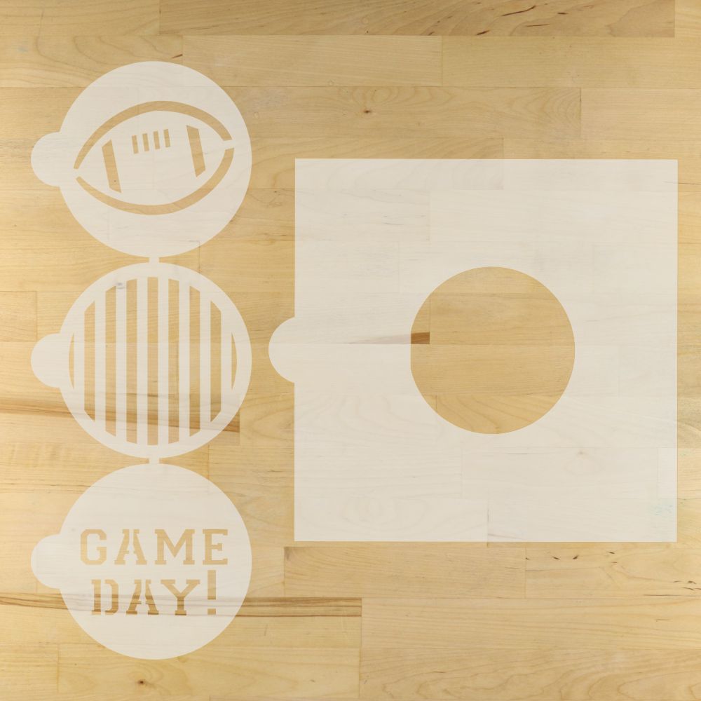 Gameday round stencils and the round cookie stencil adapter on a wooden surface