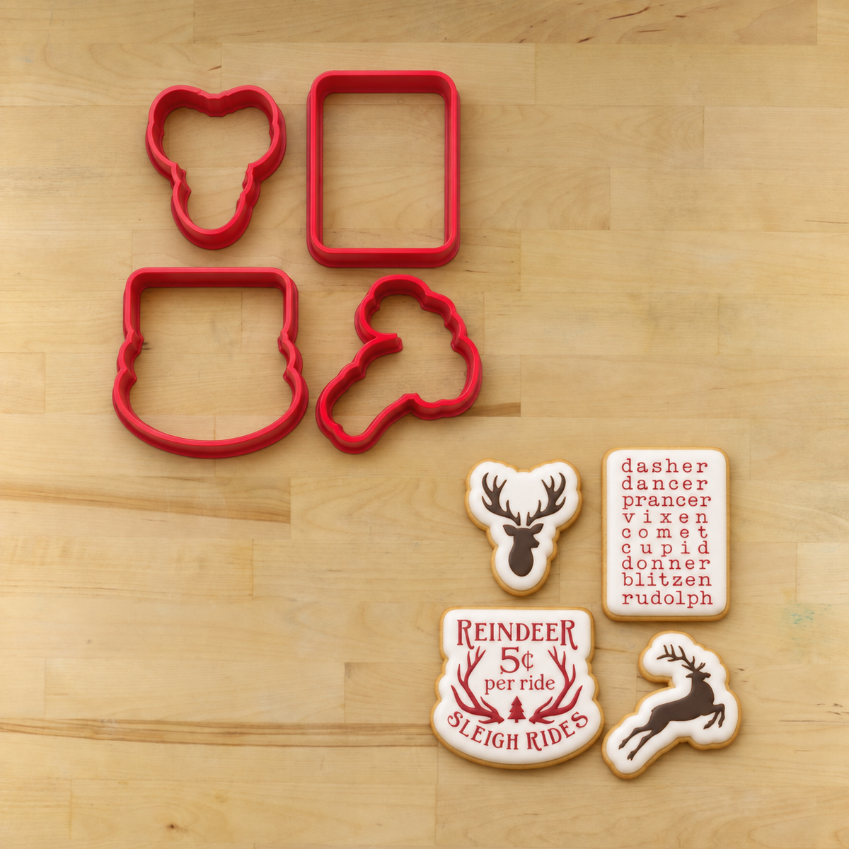 Cookies decorated with the Reindeer Games cookie stencils lying next to their matching cookie cutters.