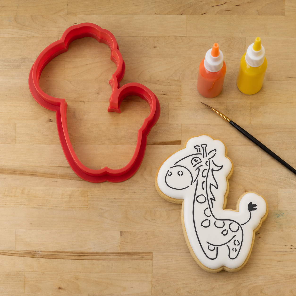 Giraffe Paint Your Own Cookie Next to Its matching giraffe shaped cookie cutter