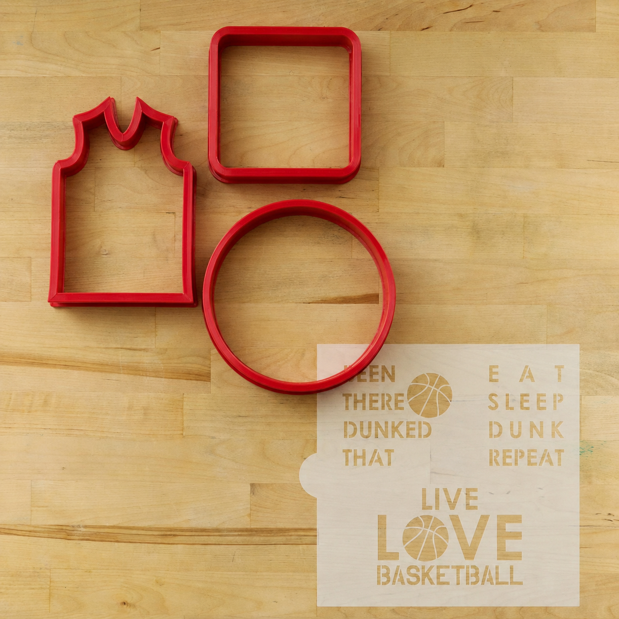 Basketball Messages Cookie Stencil Sheet lying next to three companion plastic cookie cutters