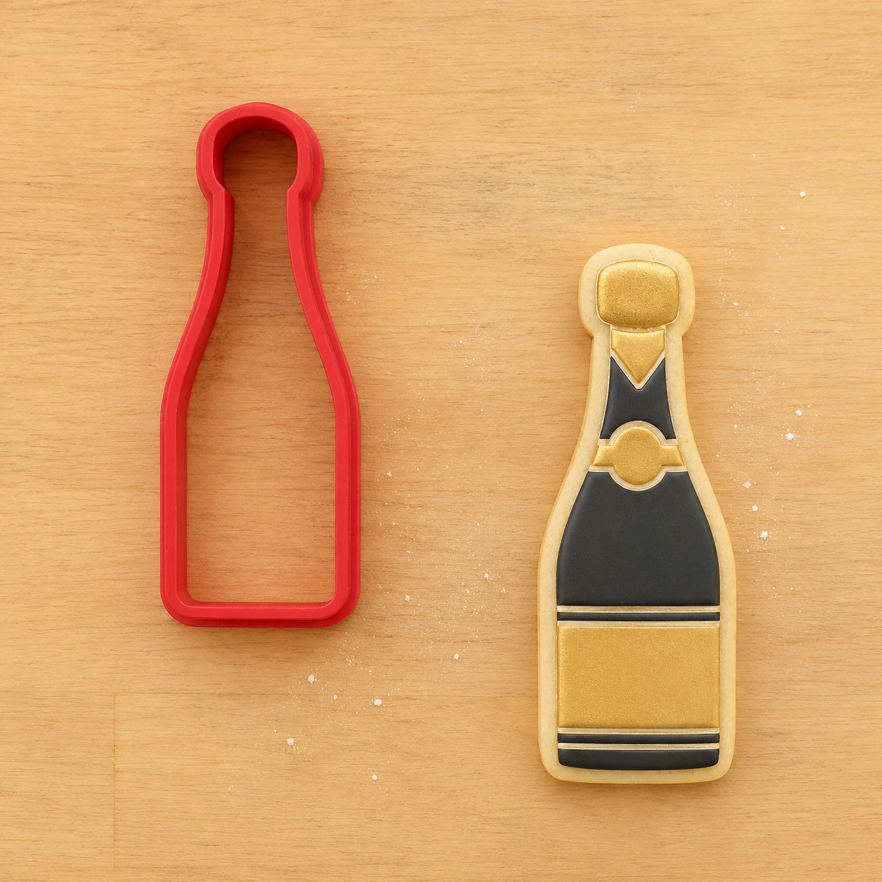 Champagne Bottle Cookie next to a matching champagne bottle cookie cutter