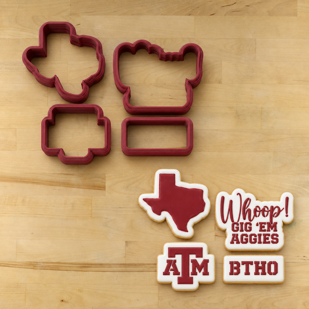 Aggies Cookie Cutters lying next to matching cookies using the Aggies Cookie Stencil Set