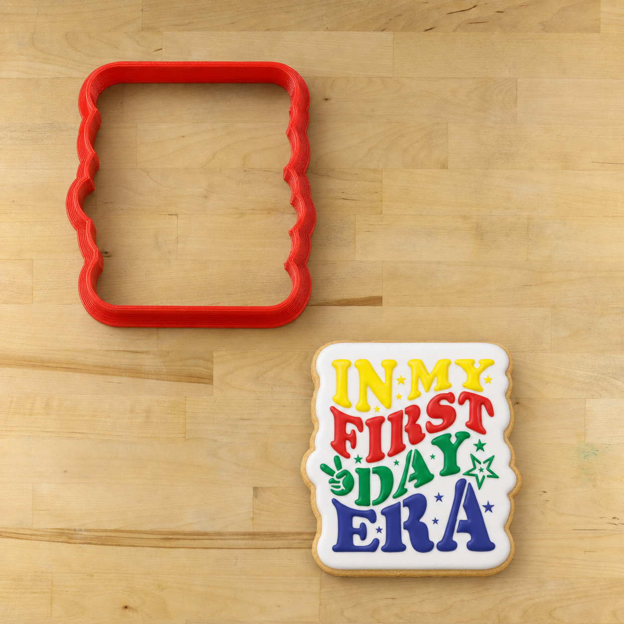 Cookie that has been cut out with the First Day Era Back to School Cookie Stencil cookie cutter, then iced and stenciled with the First Day Era Back to School Cookie Stencil 