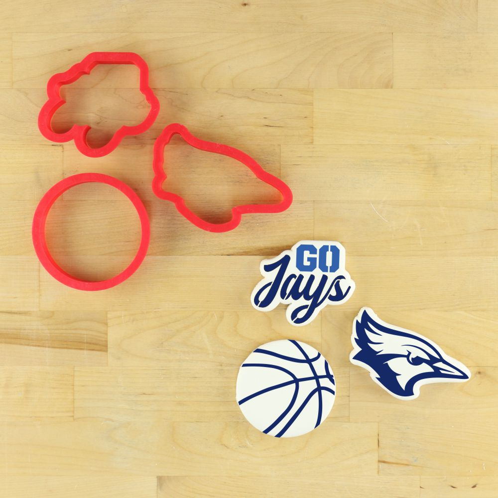 Go Jays cookie stencil set with cookie cutters and basketball-themed decorations on a wooden surface.