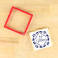 To Mom tile cookie stencil with red frame and decorated cookie, perfect for Mother's Day baking.