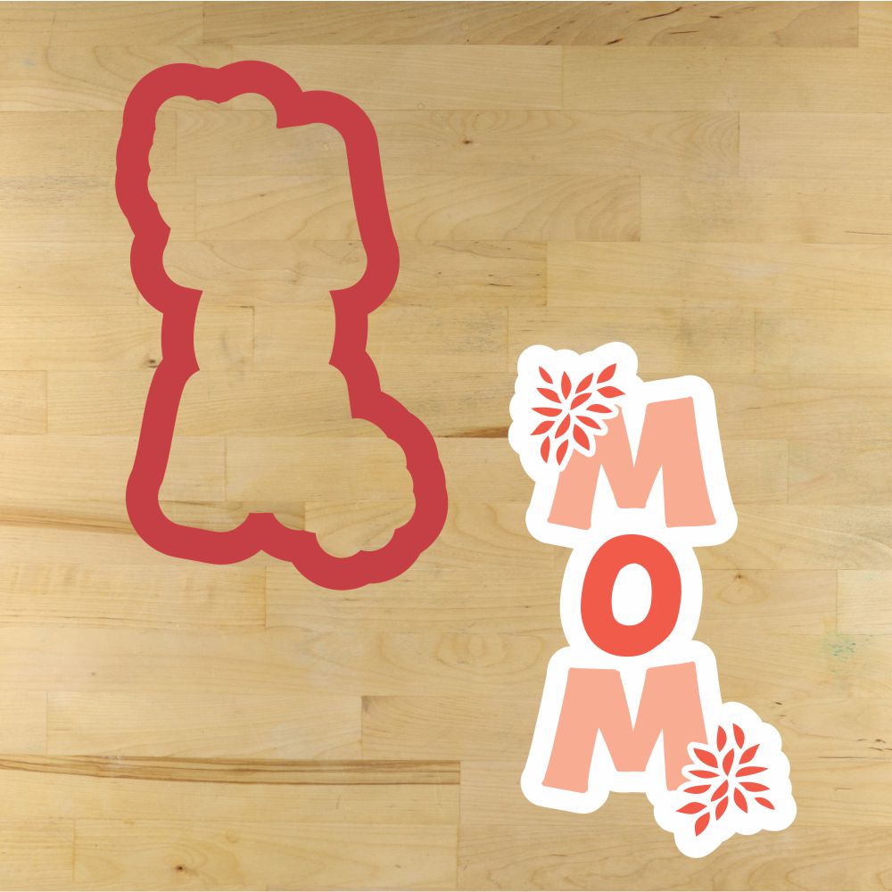 Chrysanthemum Mom cookie stencil and cutter for Mother's Day baking on a wooden surface.