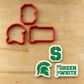 Four red cookie cutters arranged on a light wood surface, with three decorated sugar cookies shown below them featuring the Michigan State Spartans logo and the phrase 'go GREEN yo'WHITE'.