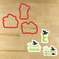 Team Green Cookie Stencil Set featuring red cookie shapes and themed designs on a wooden surface.