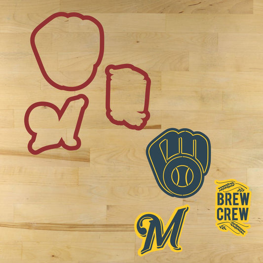 Cookie cutters with brewers-themed designs on a wooden surface, including a glove, helmet, and 'Brew Crew' logo.
