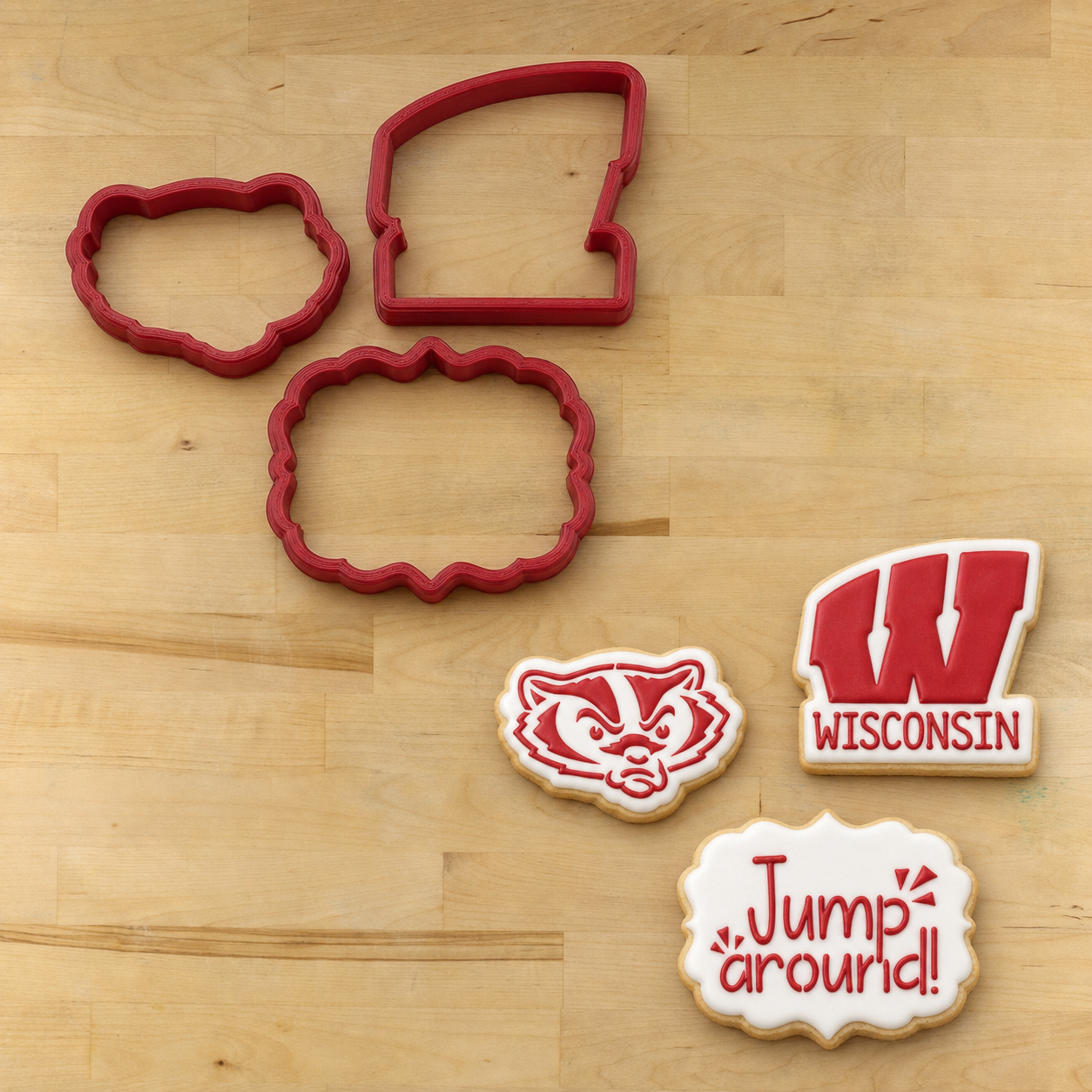 Wisconsin Badgers Cookie Stencil Set with a mockup of the matching cookie cutters on a wooden table
