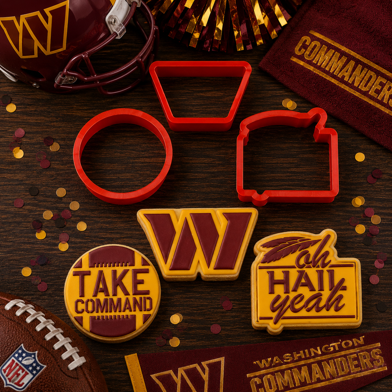 Set of cookie cutters and cookies with Washington Commanders branding on a wooden surface.