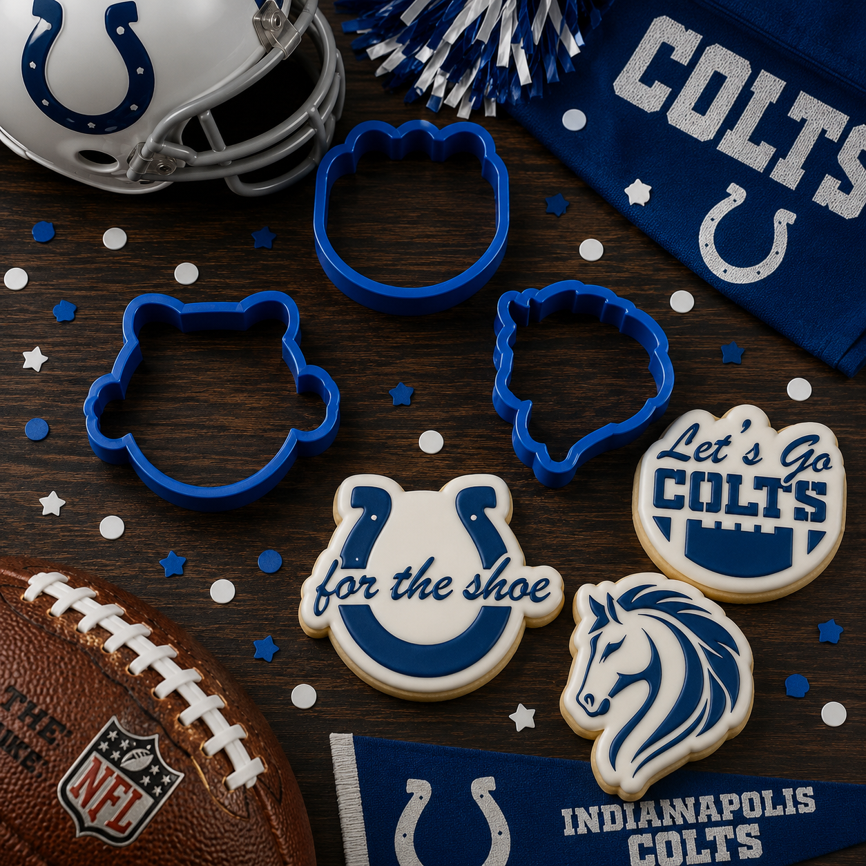 Indy Colts-themed cookies, cookie cutters, and sports memorabilia on a wooden surface.