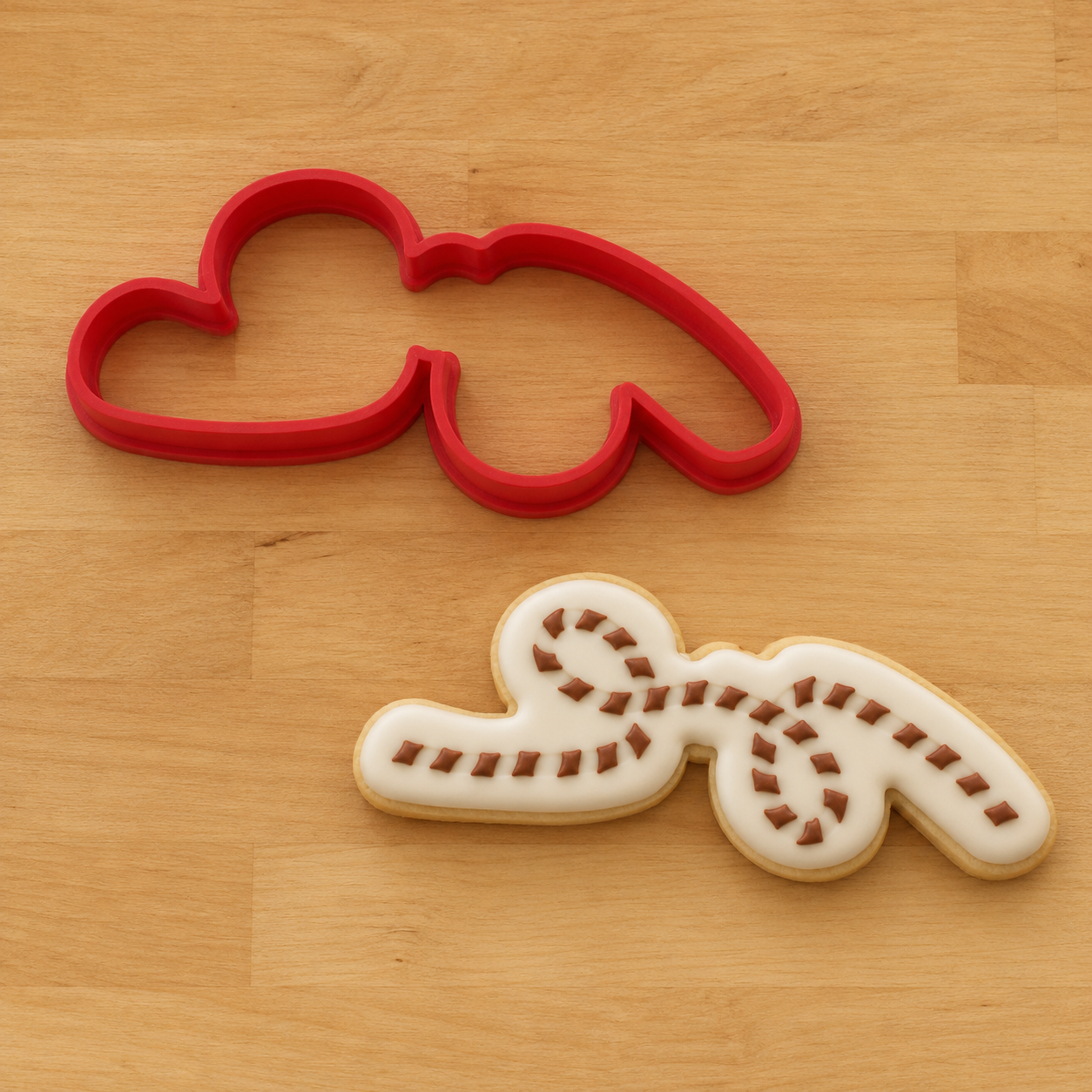 A 3D Printed cookie cutter shaped like a lasso rope and a decorated cookie using the lasso rope cookie stencil