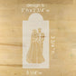 Wooden cutout of a bride and groom with measurements on a wooden surface