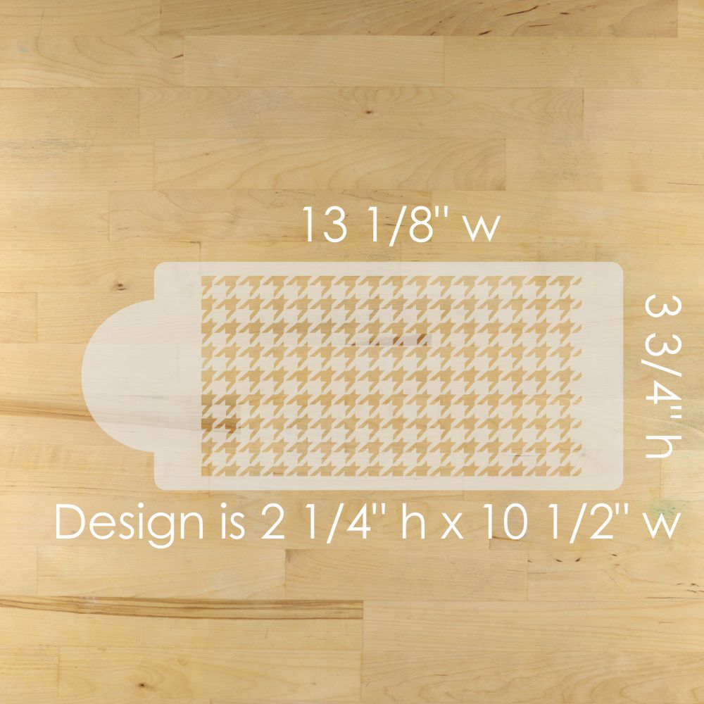 Cake stencil with houndstooth pattern on a wooden table, showing measurements.