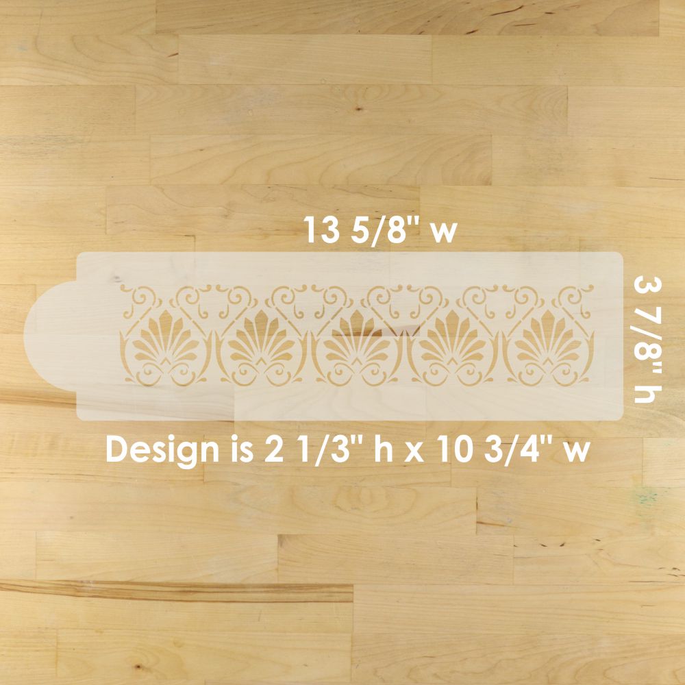 Decorative cake border stencil with measurements on a wooden surface