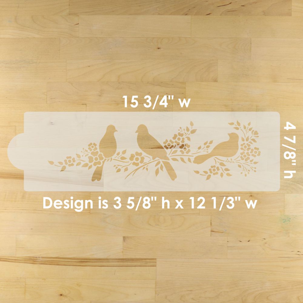 Decorative stencil with bird design on a wooden surface