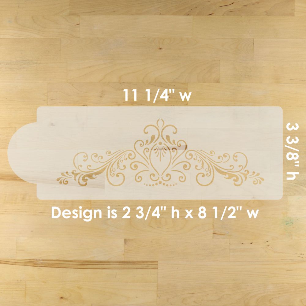 Decorative cake stenciled design on a wooden surface with measurements indicated.