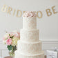Chic rose stencil applied to the sides of a cake for a bridal shower