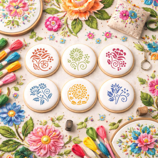 Decorative cookies with floral patterns surrounded by colorful flowers and tools on a light background