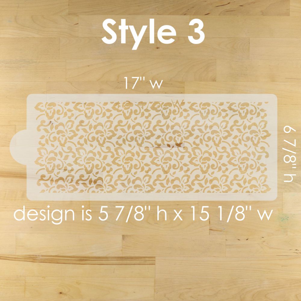 Decorative stenciled design on a wooden surface with measurements.