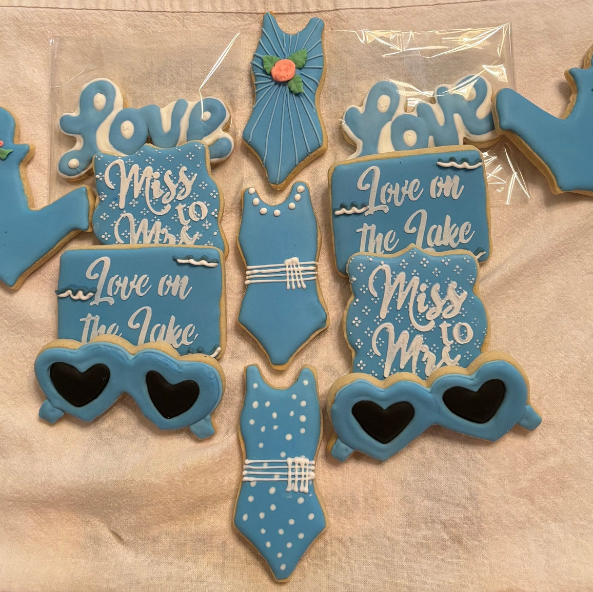 Decorative cookies with text and designs on a wooden surface