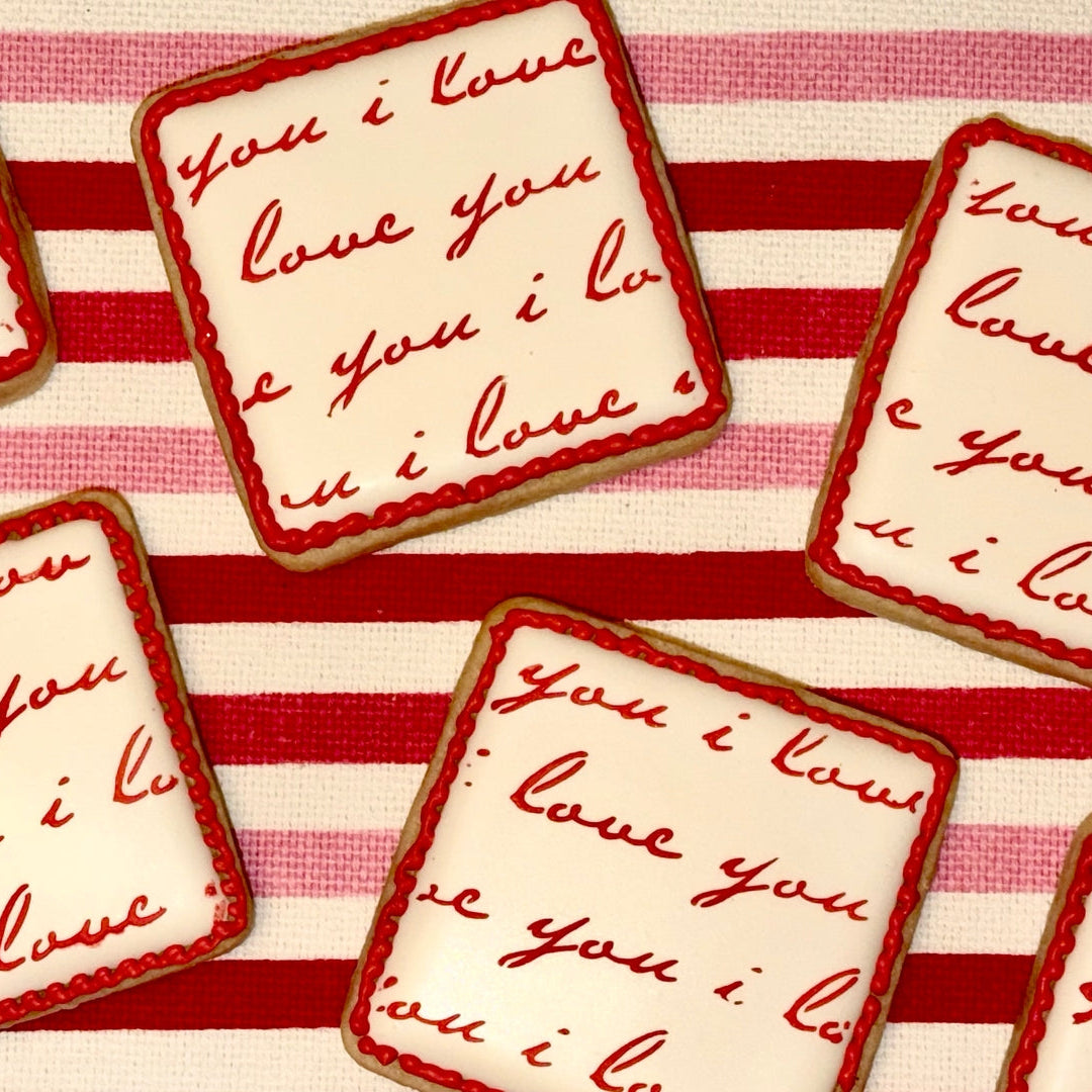 Cookies with 'I love you' text on a red and white striped background