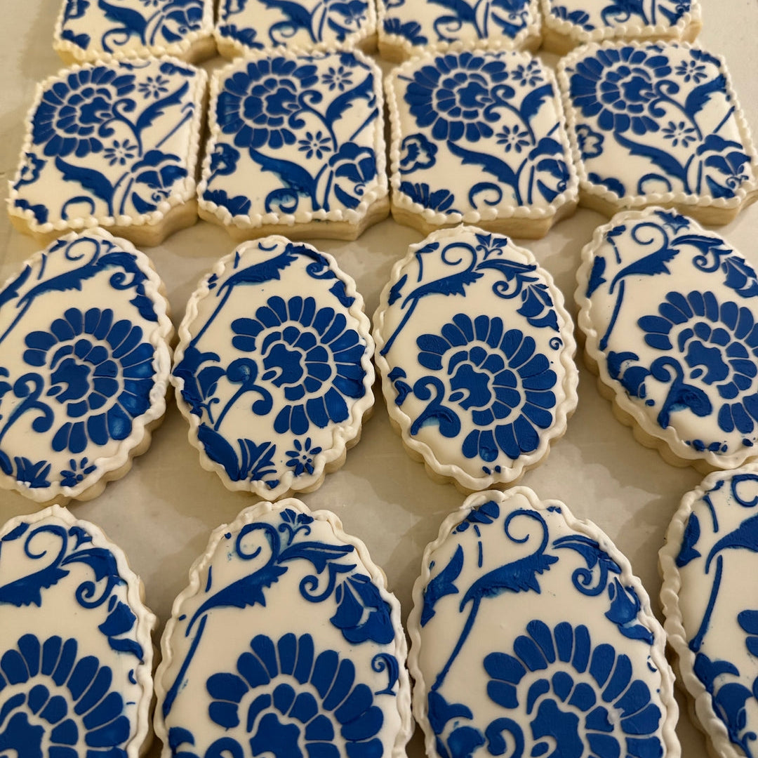 Cookies with blue floral patterns on a white surface
