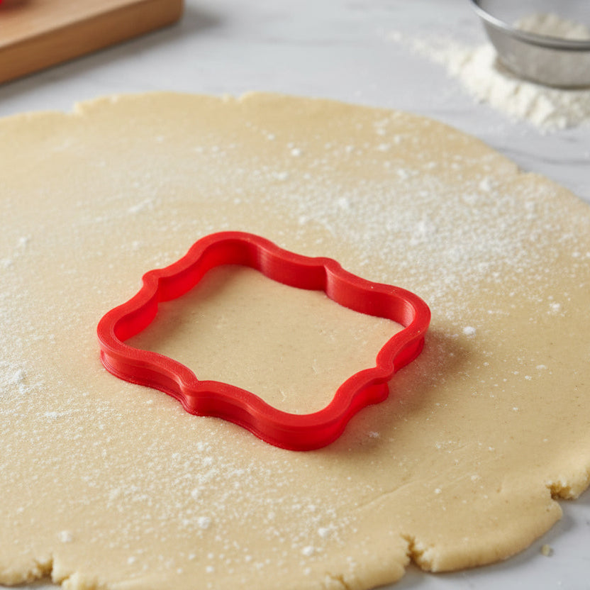 Top view of Chilton Plaque Cookie Cutter being used on cookie dough
