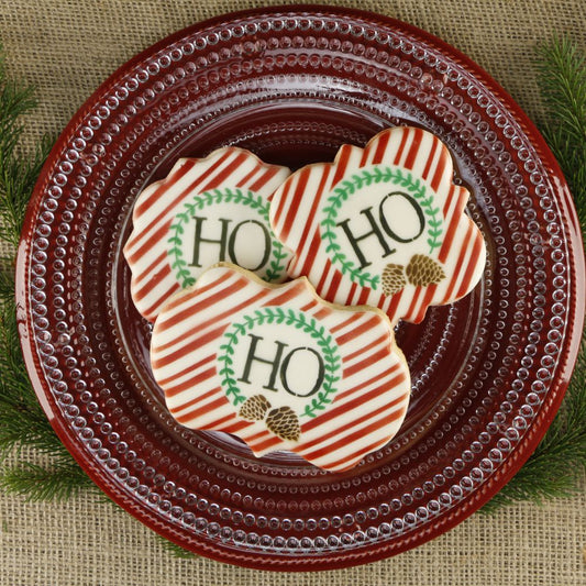 Monogrammed cookies decorated with candy cane stripe background stencil and alphabet set.